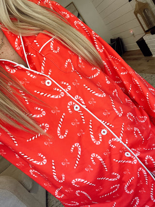 Red pajama top with candy cane pattern on a white background