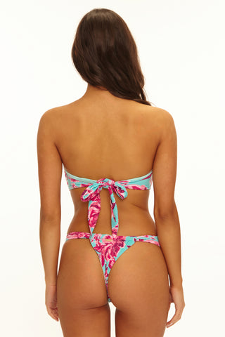 Woman wearing a colorful bikini set on a white background