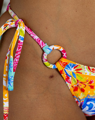 Colorful bikini with a floral pattern on a brown background