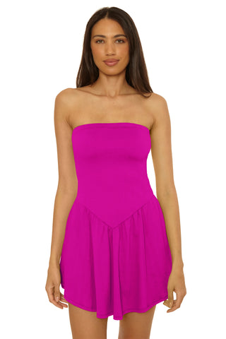 Woman wearing a strapless pink dress on a white background