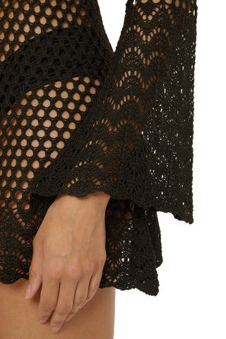 Black crochet top with a close-up of a hand wearing it on a white background