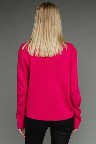 Person wearing a bright pink sweater on a gray background